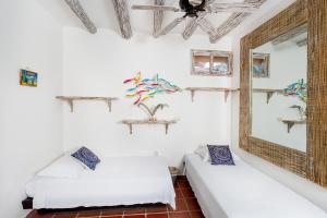 Postel nebo postele na pokoji v ubytování Holbox Dream Beachfront Hotel