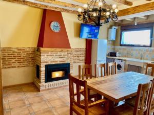 a dining room with a table and a fireplace at La Parada de Jimena-Casa rústica rodeada de bodegas en Rueda in Rueda
