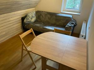 a living room with a table and a couch at Martinov dom in Kranjska Gora