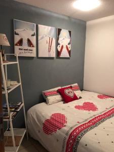 a bedroom with a bed and some pictures on the wall at The chalet de la Meije - Facing the Plateau d'Emparis in La Grave