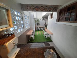 a room with benches and a table and chairs at iHOSTEL ALDEOTA in Fortaleza