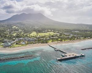 eine Luftansicht auf einen Strand mit einem Pier in der Unterkunft Four Seasons Resort Nevis in Nevis