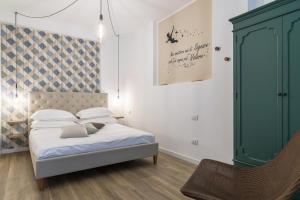 a bedroom with a bed and a green cabinet at SPAZIO M&M CELLINI 3 in Milan