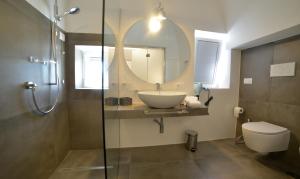 a bathroom with a sink and a mirror and a toilet at Sunshine Luxury Rooms in Ostuni +26 photos
