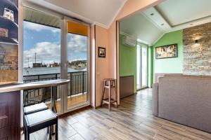 a room with a balcony with a view of the city at Apartments “U prawnika” in Lviv