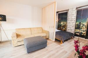 a living room with a couch and a chair at Aparthotel Rosa 404 in Podčetrtek