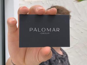 a person holding a black card in their hand at Petit Palomar - PalomarGroup in Valencia