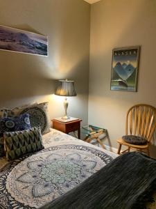 a bedroom with a bed and a chair at Mountain Meadows Inn in Ashford
