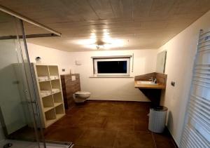 a bathroom with a toilet and a sink and a window at Exklusive Naturoase direkt am Ars Natura Wanderweg mit Panoramablick auf Melsungen in Melsungen +32 photos