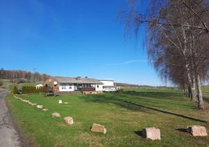 a house in a field with rocks in the grass at Exklusive Naturoase direkt am Ars Natura Wanderweg mit Panoramablick auf Melsungen in Melsungen