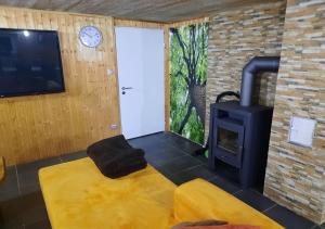 a living room with a wood stove and a door at Exklusive Naturoase direkt am Ars Natura Wanderweg mit Panoramablick auf Melsungen in Melsungen