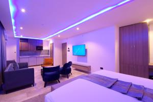 a bedroom with a bed and a living room at The Corniche Hotel in Lagos
