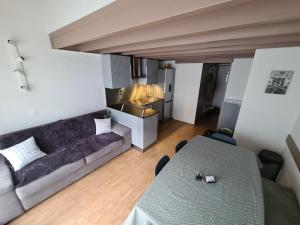 a living room with a couch and a table at Corniche de la Plage classé 3 étoiles in Bénodet