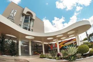 a large white building with a curved roof at Hotel Caverá in Alegrete