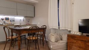 a kitchen with a table and chairs and a kitchen with a couch at Lo Scricciolo in Rovereto