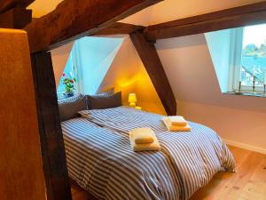 a bedroom with a bed with two towels on it at Burg Maisonette im Posthalterhof mit Sauna in Blankenheim