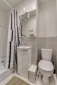 グリヴィツェにあるApartament Szczęśliwa Trzynastkaの白いバスルーム(トイレ、シンク付)