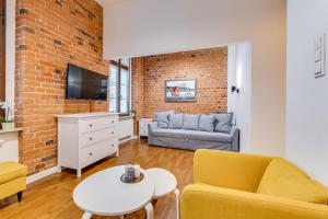 a living room with a couch and a table at Apartament Uroczy Zakątek in Gliwice