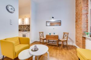 a living room with a couch and a table at Apartament Uroczy Zakątek in Gliwice