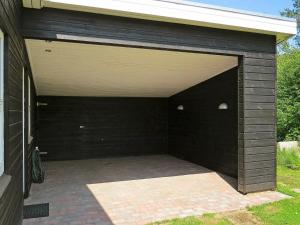 un garage noir avec deux lumières au-dessus dans l'établissement 8 person holiday home in Hals, à Øster Melholt