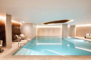 a large swimming pool in a hotel room at Hyatt Regency Malta in St. Julianʼs
