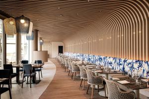 a row of tables and chairs in a restaurant at Hyatt Regency Malta in St. Julianʼs