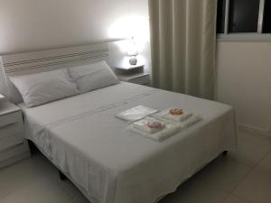 A bed or beds in a room at Apartamento com vista pro mar e acesso privativo à praia!