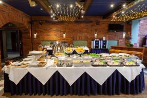 a long table with food on it in a room at BEST WESTERN Santakos Hotel in Kaunas