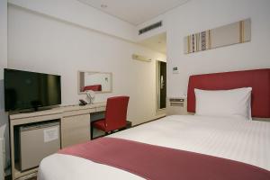 Un pat sau paturi într-o cameră la Mars Garden Hotel Hakata