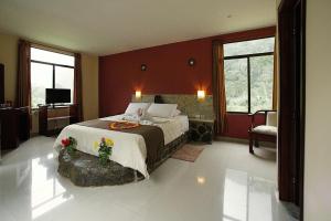 a bedroom with a large bed in a room at Santval Lodge in Bucay