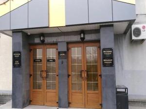a building with three wooden doors in front of it at Ostrovok in Vladivostok