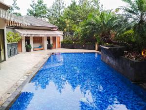 una piscina nel cortile di una casa di Strategic & Cozy 2BR at Majesty Apartment near Maranatha Christian University By Travelio a Bandung