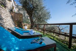 a pool with a bed and a table on a balcony at Maison Don Rafe' in Positano