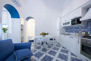 a kitchen with blue and white tiles on the floor at Maison Don Rafe' in Positano +54 photos