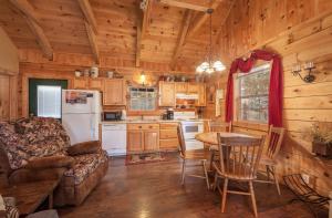 a kitchen and living room with a couch and a table at Sleepin' Inn Holiday home in Sevierville