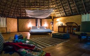 a bedroom with a bed and a hammock in a room at The Barefoot At Havelock in Havelock Island