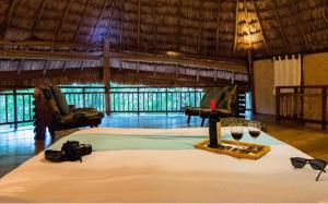 a room with a bed with glasses of wine at The Barefoot At Havelock in Havelock Island