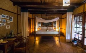 a bedroom with a bed with a canopy at The Barefoot At Havelock in Havelock Island