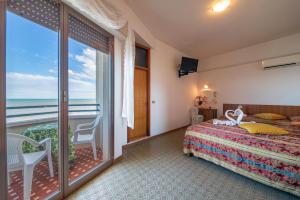 a bedroom with a bed and a balcony with the ocean at Hotel Majestic in Bellaria-Igea Marina +72 photos