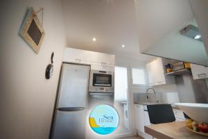 a small kitchen with a refrigerator and a sink at SEA HOME vue mer in Cassis