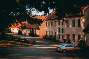 a car parked on a street next to buildings at Šlokenbekas Muiža in Milzkalne