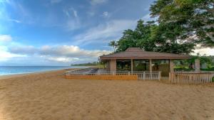 a gazebo on a sandy beach next to the ocean at Maui Eldorado - J207 in Lahaina