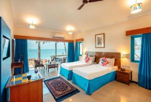 En eller flere senge i et værelse på Bambolim Beach Resort