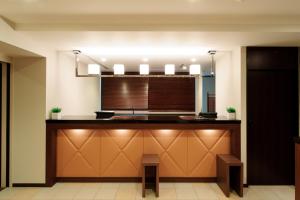 a kitchen with a counter with a sink at Osaka Fujiya Hotel in Osaka