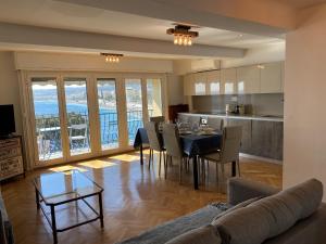 a living room with a dining table and a kitchen at PROMENADE HOLIDAY - OLD TOWN PANORAMIC in Nice