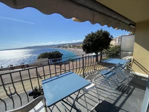 a balcony with tables and chairs and a view of the water at PROMENADE HOLIDAY - OLD TOWN PANORAMIC in Nice