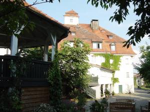 a large white building with a clock tower at Gasthof Russenbräu in Tiefenbach