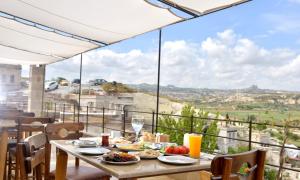 a table with food on top of a balcony at Seki Cave Hotel, Wake Up to Hot Air Balloons in Göreme