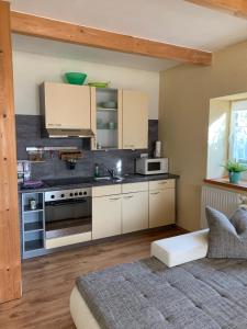 a kitchen with white cabinets and a stove top oven at Lindenhof in Hecklingen