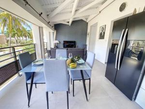 a dining room with a table and a refrigerator at From Paris to SXM - luxury next to Anse Marcel Beach in Anse Marcel 